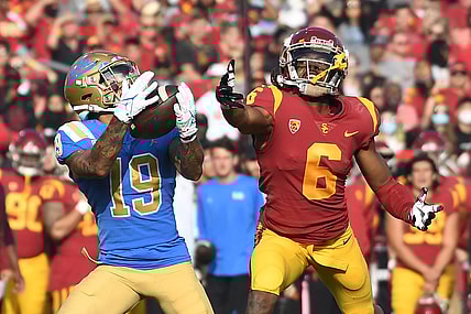 Nov 20, 2021; Los Angeles, California, USA;  UCLA Bruins running back Kazmeir Allen (19) catches a touchdown pass against Southern California Trojans cornerback Isaac Taylor-Stuart (6) in the first half at the Los Angeles Memorial Coliseum. Mandatory Credit: Richard Mackson-USA TODAY Sports