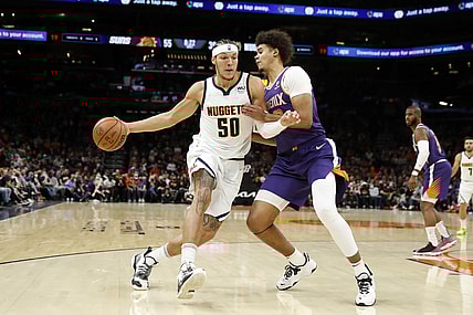 Nov 21, 2021; Phoenix, Arizona, USA; Phoenix Suns forward Cameron Johnson (23) defends Denver Nuggets forward Aaron Gordon (50) during the first half at Footprint Center. Mandatory Credit: Chris Coduto-USA TODAY Sports