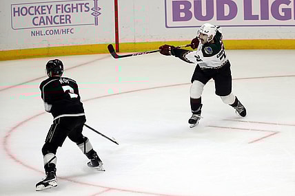 Nov 21, 2021; Los Angeles, California, USA; Arizona Coyotes defenseman Kyle Capobianco (75) shoots the game winning shot in the overtime against the Los Angeles King at Staples Center. The Coyotes wins 2-1. Mandatory Credit: Kiyoshi Mio-USA TODAY Sports
