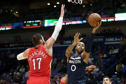 Nov 22, 2021; New Orleans, Louisiana, USA; Minnesota Timberwolves guard D'Angelo Russell (0) shoots while defended by New Orleans Pelicans center Jonas Valanciunas (17) in the first quarter at the Smoothie King Center. Mandatory Credit: Chuck Cook-USA TODAY Sports