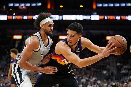 Nov 22, 2021; San Antonio, Texas, USA;  Phoenix Suns guard Devin Booker (1) backs in to San Antonio Spurs guard Derrick White (4) in the first half at the AT&T Center. Mandatory Credit: Daniel Dunn-USA TODAY Sports