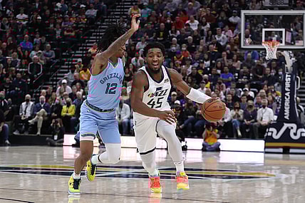 Nov 22, 2021; Salt Lake City, Utah, USA; Utah Jazz guard Donovan Mitchell (45) bring the ball up the court defended by Memphis Grizzlies guard Ja Morant (12) in the second quarter at Vivint Arena. Mandatory Credit: Rob Gray-USA TODAY Sports