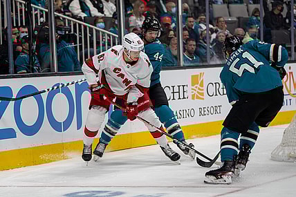 Nov 22, 2021; San Jose, California, USA;  San Jose Sharks defenseman Marc-Edouard Vlasic (44) and defenseman Radim Simek (51) battle for the puck against Carolina Hurricanes center Jesperi Kotkaniemi (82) behind the net during the first period at SAP Center at San Jose. Mandatory Credit: Neville E. Guard-USA TODAY Sports