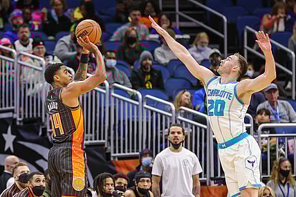 Nov 24, 2021; Orlando, Florida, USA; Orlando Magic guard Gary Harris (14) shoots the ball against Charlotte Hornets forward Gordon Hayward (20) during the first quarter at Amway Center. Mandatory Credit: Mike Watters-USA TODAY Sports