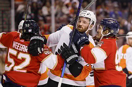 Nov 24, 2021; Sunrise, Florida, USA; Florida Panthers defenseman MacKenzie Weegar (52) pushes Philadelphia Flyers center Sean Couturier (14) during the first period at FLA Live Arena. Mandatory Credit: Sam Navarro-USA TODAY Sports