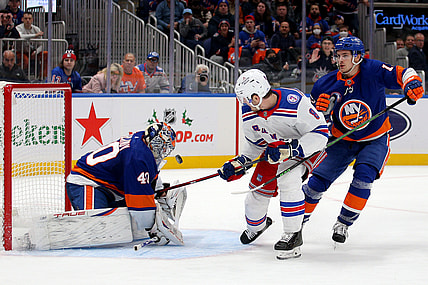 Nov 24, 2021; Elmont, New York, USA; New York Islanders goaltender Semyon Varlamov (40) makes a save against New York Rangers defenseman Jacob Trouba (8) in front of Islanders center Mathew Barzal (13) during the first period at UBS Arena. Mandatory Credit: Brad Penner-USA TODAY Sports