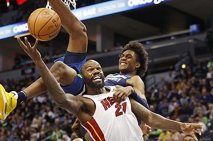Nov 24, 2021; Minneapolis, Minnesota, USA; Minnesota Timberwolves forward Jaden McDaniels (3) fouls Miami Heat center Dewayne Dedmon (21) in the first quarter at Target Center. Mandatory Credit: Bruce Kluckhohn-USA TODAY Sports
