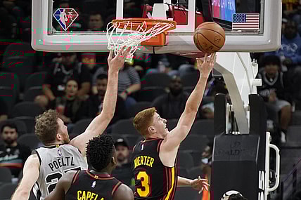Nov 24, 2021; San Antonio, Texas, USA; Atlanta Hawks guard Kevin Huerter (3) drives to the basket past San Antonio Spurs center Jakob Poeltl (25) during the first half at AT&T Center. Mandatory Credit: Scott Wachter-USA TODAY Sports