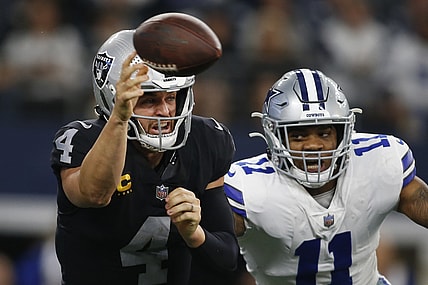Nov 25, 2021; Arlington, Texas, USA; Las Vegas Raiders quarterback Derek Carr (4) throws a pass while Dallas Cowboys outside linebacker Micah Parsons (11) defends in the second quarter at AT&T Stadium. Mandatory Credit: Tim Heitman-USA TODAY Sports