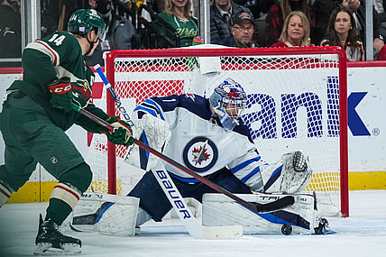 Nov 26, 2021; Saint Paul, Minnesota, USA; Winnipeg Jets goalie Eric Comrie (1) makes a save during the second period against the Minnesota Wild at Xcel Energy Center. Mandatory Credit: Brace Hemmelgarn-USA TODAY Sports