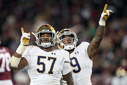 Nov 27, 2021; Stanford, California, USA; Notre Dame Fighting Irish defensive lineman Jayson Ademilola (57) celebrates with defensive lineman Justin Ademilola (9) after a sack during the third quarter against the Stanford Cardinal at Stanford Stadium. Mandatory Credit: Darren Yamashita-USA TODAY Sports