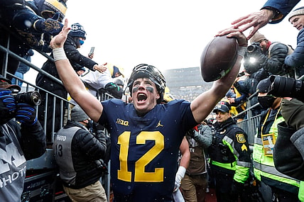 Nov 27, 2021; Ann Arbor, MI, USA; Michigan quarterback Cade McNamara celebrates with fans as he walks up the tunnel after Michigan's 42-27 win over Ohio State on Saturday, Nov. 27, 2021, at Michigan Stadium. Mandatory Credit: Junfu Han-USA TODAY Sports