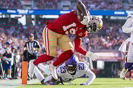 November 28, 2021; Santa Clara, California, USA; San Francisco 49ers wide receiver Deebo Samuel (19) scores a touchdown against Minnesota Vikings free safety Xavier Woods (23) during the first quarter at Levi's Stadium. Mandatory Credit: Kyle Terada-USA TODAY Sports