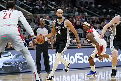 Nov 29, 2021; San Antonio, Texas, USA;  San Antonio Spurs guard Derrick White (4) dribbles past Washington Wizards guard Bradley Beal (3) in the first half at the AT&T Center. Mandatory Credit: Daniel Dunn-USA TODAY Sports