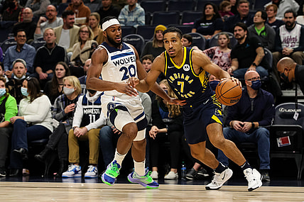 Nov 29, 2021; Minneapolis, Minnesota, USA; Indiana Pacers guard Malcolm Brogdon (7) drives to the basket while Minnesota Timberwolves forward Josh Okogie (20) defends in the first quarter at Target Center. Mandatory Credit: David Berding-USA TODAY Sports
