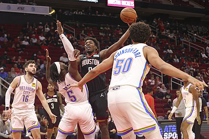 Nov 29, 2021; Houston, Texas, USA; Houston Rockets forward Jae'Sean Tate (8) drives against Oklahoma City Thunder forward Luguentz Dort (5) in the second quarter at Toyota Center. Mandatory Credit: Thomas Shea-USA TODAY Sports
