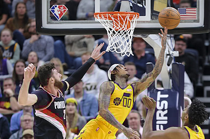 Nov 29, 2021; Salt Lake City, Utah, USA; Utah Jazz guard Jordan Clarkson (00) is fouled by Portland Trail Blazers center Jusuf Nurkic (27) as he attempts a layup during the second quarter at Vivint Arena. Mandatory Credit: Rob Gray-USA TODAY Sports