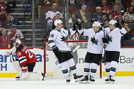 Nov 30, 2021; Newark, New Jersey, USA; San Jose Sharks defenseman Erik Karlsson (65) celebrates with left wing Alexander Barabanov (94) and left wing Rudolfs Balcers (92) after scoring a goal against New Jersey Devils during the second period at Prudential Center. Mandatory Credit: Tom Horak-USA TODAY Sports