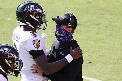 Oct 4, 2020; Landover, Maryland, USA; Baltimore Ravens quarterback Lamar Jackson (8) hugs Ravens head coach John Harbaugh (R) after scoring a touchdown against the Washington Football Team at FedExField. Mandatory Credit: Geoff Burke-USA TODAY Sports