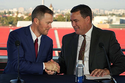 Nov 29, 2021; Los Angeles, CA, USA; Lincoln Riley (left) and Southern California Trojans athletic director Mike Bohn shake hands during a press conference to introduce Riley as USC head coach at the Los Angeles Memorial Coliseum. Mandatory Credit: Kirby Lee-USA TODAY Sports