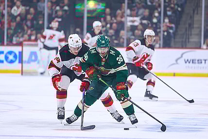 Dec 2, 2021; Saint Paul, Minnesota, USA; Minnesota Wild right wing Mats Zuccarello (36) and New Jersey Devils right wing Nathan Bastian (14) fight for the puck during the first period at Xcel Energy Center. Mandatory Credit: Harrison Barden-USA TODAY Sports