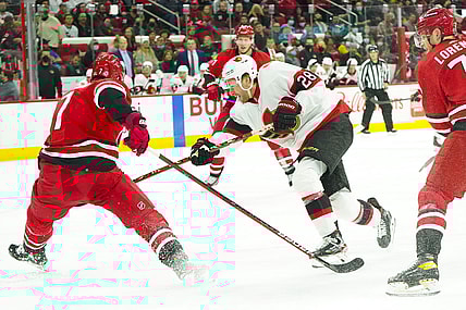 Dec 2, 2021; Raleigh, North Carolina, USA;  Ottawa Senators right wing Connor Brown (28) shoots against Carolina Hurricanes defenseman Brendan Smith (7) during the second period at PNC Arena. Mandatory Credit: James Guillory-USA TODAY Sports