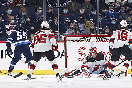 Dec 3, 2021; Winnipeg, Manitoba, CAN; Winnipeg Jets center Mark Scheifele (55) scores on New Jersey Devils goaltender Jonathan Bernier (45) in the first period at Canada Life Centre. Mandatory Credit: James Carey Lauder-USA TODAY Sports