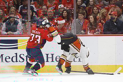 Dec 6, 2021; Washington, District of Columbia, USA; Washington Capitals left wing Conor Sheary (73) checks Anaheim Ducks right wing Vinni Lettieri (28) during the first period at Capital One Arena. Mandatory Credit: Geoff Burke-USA TODAY Sports