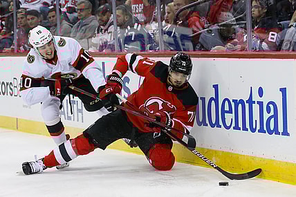 Dec 6, 2021; Newark, New Jersey, USA; New Jersey Devils defenseman Jonas Siegenthaler (71) moves the puck past Ottawa Senators left wing Alex Formenton (10) during the first period at Prudential Center. Mandatory Credit: Tom Horak-USA TODAY Sports