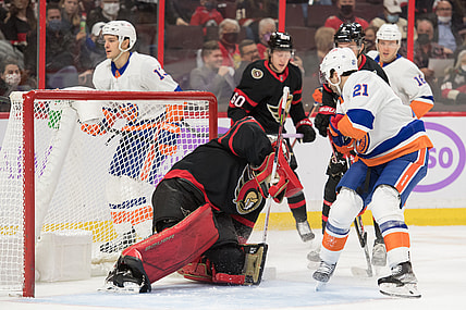 Dec 7, 2021; Ottawa, Ontario, CAN; Ottawa Senators goalie Filip Gustavsson (32) makes a save in front of New York Islanders center Kyle Palmieri (21) in the first period at the Canadian Tire Centre. Mandatory Credit: Marc DesRosiers-USA TODAY Sports