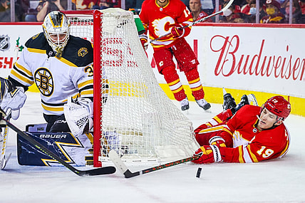 Dec 11, 2021; Calgary, Alberta, CAN; Calgary Flames left wing Matthew Tkachuk (19) reach for the puck in front of Boston Bruins goaltender Linus Ullmark (35) during the first period at Scotiabank Saddledome. Mandatory Credit: Sergei Belski-USA TODAY Sports