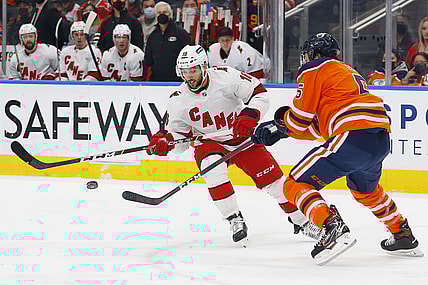 Dec 11, 2021; Edmonton, Alberta, CAN; Carolina Hurricanes forward Vincent Trocheck (16) and Edmonton Oilers defensemen Cody Ceci (5) battle for a loose puck during the second period at Rogers Place. Mandatory Credit: Perry Nelson-USA TODAY Sports