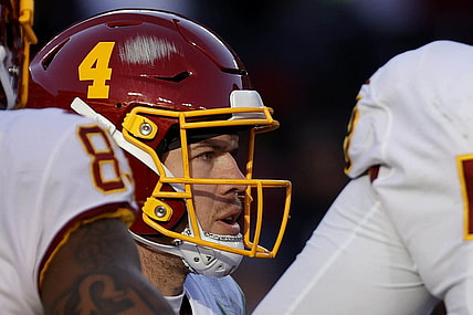 Dec 12, 2021; Landover, Maryland, USA; Washington Football Team quarterback Taylor Heinicke (4) stands in the huddle against the Dallas Cowboys at FedExField. Mandatory Credit: Geoff Burke-USA TODAY Sports