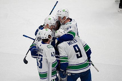 Dec 16, 2021; San Jose, California, USA; Vancouver Canucks center J.T. Miller (9), defenseman Quinn Hughes (43), defenseman Tyler Myers (57) and left wing Tanner Pearson (70) celebrate after a goal during the third period against the San Jose Sharksat SAP Center at San Jose. Mandatory Credit: Neville E. Guard-USA TODAY Sports
