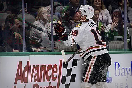 Dec 18, 2021; Dallas, Texas, USA; Chicago Blackhawks center Jonathan Toews (19) crashes into the glass during the third period against the Dallas Stars at the American Airlines Center. Mandatory Credit: Jerome Miron-USA TODAY Sports