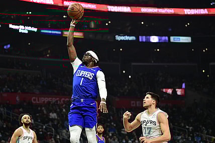 Dec 20, 2021; Los Angeles, California, USA; Los Angeles Clippers guard Reggie Jackson (1) shoots ahead of San Antonio Spurs forward Doug McDermott (17) during the first half at Staples Center. Mandatory Credit: Gary A. Vasquez-USA TODAY Sports