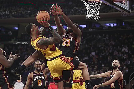 Dec 25, 2021; New York, New York, USA;  Atlanta Hawks forward John Collins (20) goes up against New York Knicks center Mitchell Robinson (23) in the first quarter at Madison Square Garden. Mandatory Credit: Wendell Cruz-USA TODAY Sports