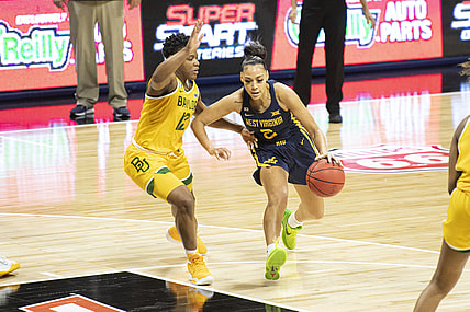 Mar 14, 2021; Kansas City, Missouri, USA; West Virginia Mountaineers guard Kysre Gondrezick (2) dribbles by Baylor Lady Bears guard Moon Ursin (12) in the second half at Municipal Auditorium. Mandatory Credit: Amy Kontras-USA TODAY Sports
