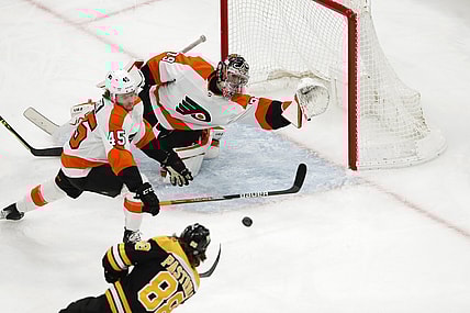 Jan 13, 2022; Boston, Massachusetts, USA; Boston Bruins right wing David Pastrnak (88) scores a goal past Philadelphia Flyers goaltender Carter Hart (79) and defenseman Cam York (45) during the first period at TD Garden. Mandatory Credit: Winslow Townson-USA TODAY Sports