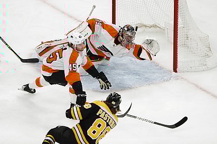 Jan 13, 2022; Boston, Massachusetts, USA; Boston Bruins right wing David Pastrnak (88) scores a goal past Philadelphia Flyers goaltender Carter Hart (79) and defenseman Cam York (45) during the first period at TD Garden. Mandatory Credit: Winslow Townson-USA TODAY Sports