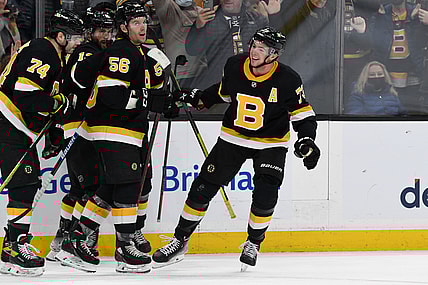 Jan 20, 2022; Boston, Massachusetts, USA; Boston Bruins defenseman Charlie McAvoy (73) celebrates with his teammates after scoring against the Washington Capitals during the third period at the TD Garden. Mandatory Credit: Brian Fluharty-USA TODAY Sports