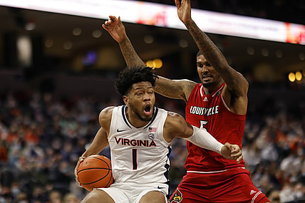 Jan 24, 2022; Charlottesville, Virginia, USA; Virginia Cavaliers forward Jayden Gardner (1) drives to the basket as Louisville Cardinals forward Malik Williams (5) defends during the second half at John Paul Jones Arena. Mandatory Credit: Geoff Burke-USA TODAY Sports