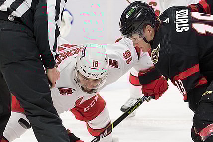 Jan 27, 2022; Ottawa, Ontario, CAN; Carolina Hurricanes cente Vincent Trocheck (16) faces off against Ottawa Senators left wing Tim St tzle (18) in the second period at the Canadian Tire Centre. Mandatory Credit: Marc DesRosiers-USA TODAY Sports