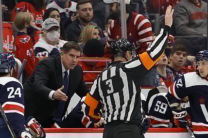 Jan 16, 2022; Washington, District of Columbia, USA; Washington Capitals head coach Peter Laviolette (L) argues a penalty call by referee Mike Leggo (3) during the game against the Vancouver Canucks during the third period at Capital One Arena. Mandatory Credit: Geoff Burke-USA TODAY Sports