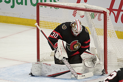 Jan 27, 2022; Ottawa, Ontario, CAN; Ottawa Senators goalie Matt Murray (30) makes a save in overtime against the Carolina Hurricanes  at the Canadian Tire Centre. Mandatory Credit: Marc DesRosiers-USA TODAY Sports