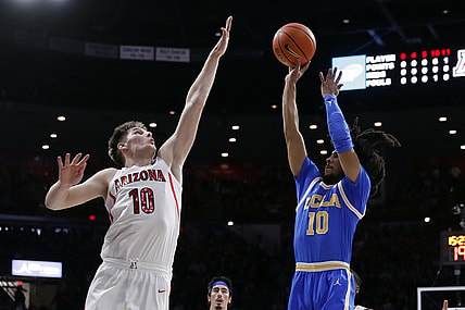 Feb 3, 2022; Tucson, Arizona, USA; UCLA Bruins guard Tyger Campbell (10) shoots over Arizona Wildcats forward Azuolas Tubelis (10) during the first half at McKale Center. Mandatory Credit: Chris Coduto-USA TODAY Sports
