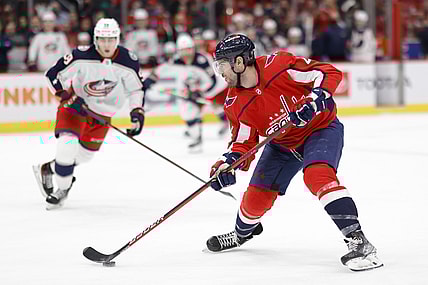 Feb 8, 2022; Washington, District of Columbia, USA; Washington Capitals defenseman Justin Schultz (2) skates with the puck as Columbus Blue Jackets right wing Yegor Chinakhov (59) chase during the third period at Capital One Arena. Mandatory Credit: Geoff Burke-USA TODAY Sports