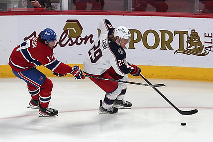 Feb 12, 2022; Montreal, Quebec, CAN; Columbus Blue Jackets left wing Patrik Laine (29) plays the puck against Montreal Canadiens right wing Josh Anderson (17) during the first period at Bell Centre. Mandatory Credit: Jean-Yves Ahern-USA TODAY Sports
