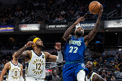 Feb 13, 2022; Indianapolis, Indiana, USA; Minnesota Timberwolves guard Patrick Beverley (22) shoots the ball while Indiana Pacers forward Oshae Brissett (12) defends in the first half at Gainbridge Fieldhouse. Mandatory Credit: Trevor Ruszkowski-USA TODAY Sports