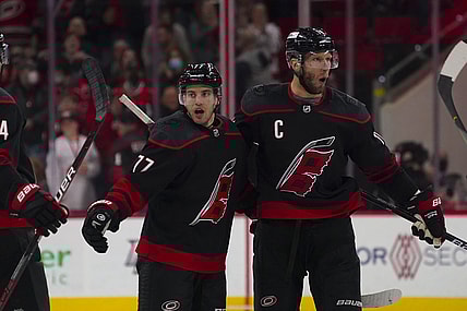 Feb 16, 2022; Raleigh, North Carolina, USA; Carolina Hurricanes defenseman Tony DeAngelo (77) is congratulated by center Jordan Staal (11) after his goal against the Florida Panthers during the third period at PNC Arena. Mandatory Credit: James Guillory-USA TODAY Sports
